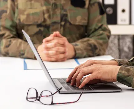 Military personnel on computers
